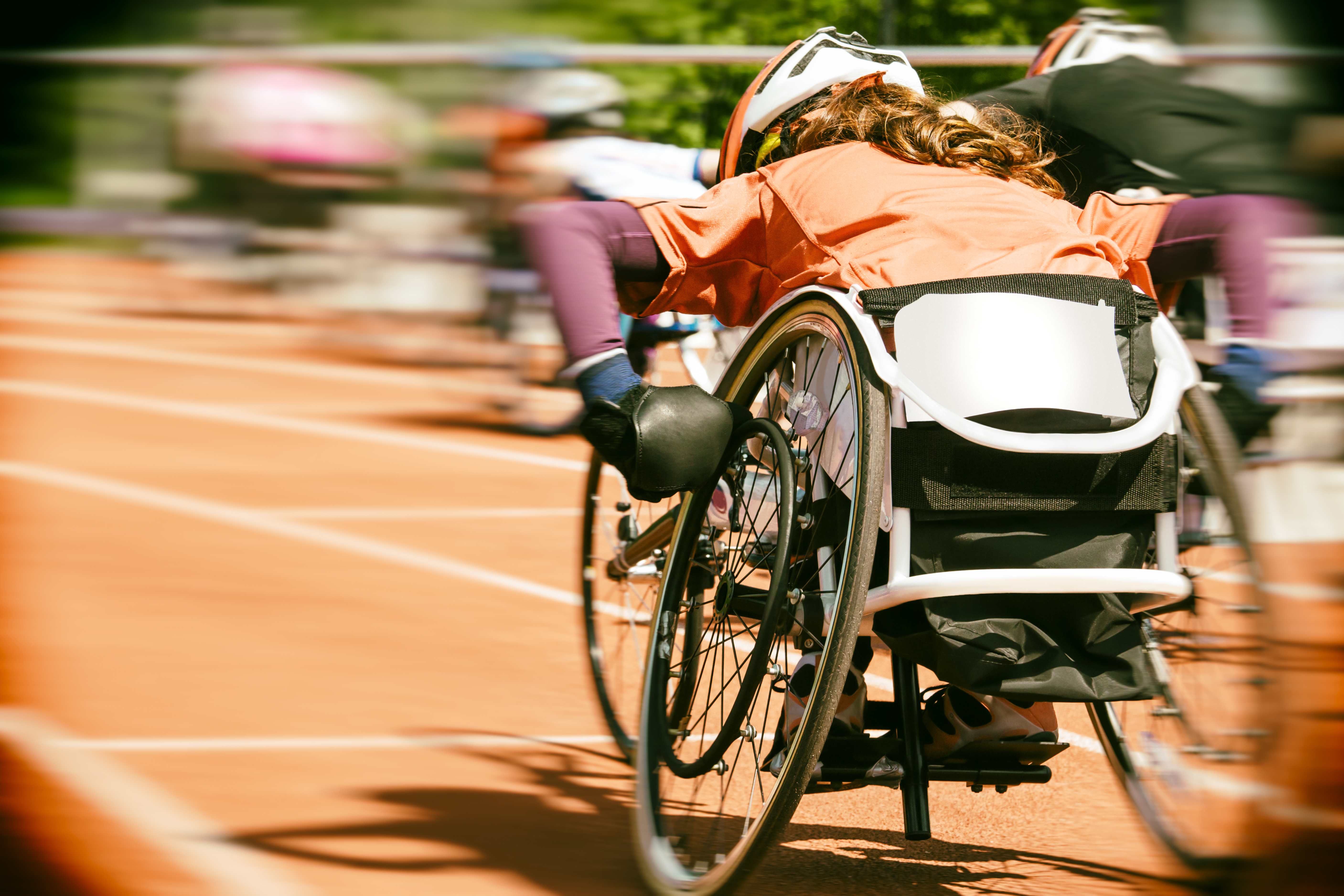 Special Olympics race using wheelchairs. Photo shows fast speed forward.