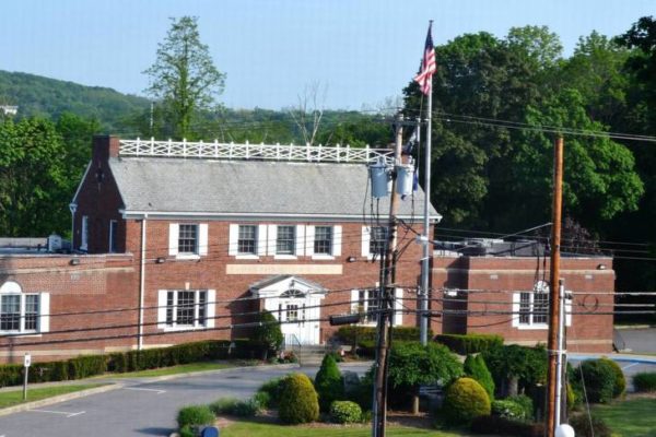 The flagpole plaza in front of town hall will be removed to make room for new handicapped spaces. Credits: File Photo/Brian Marschhauser