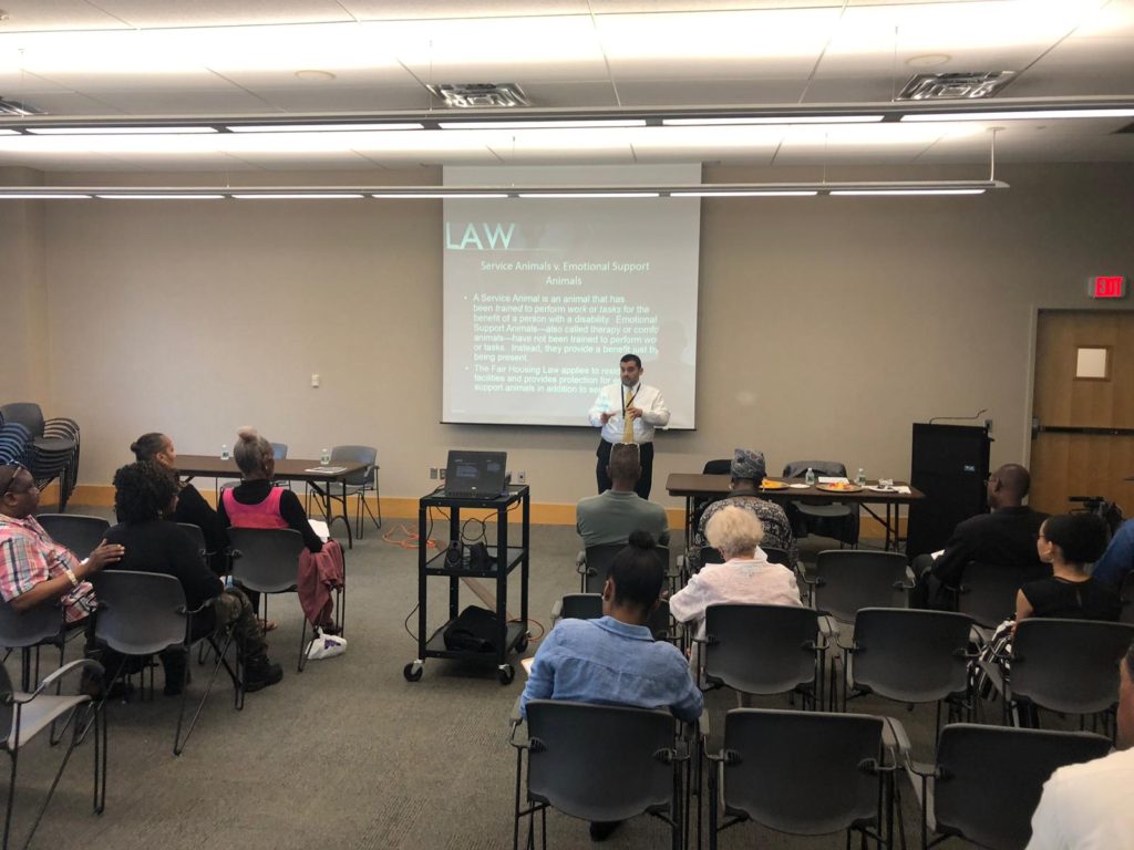 Emmanuel Segarra-Otero, Fair Housing Investigator from Westchester Human Rights Commission, talks to people seated in room.